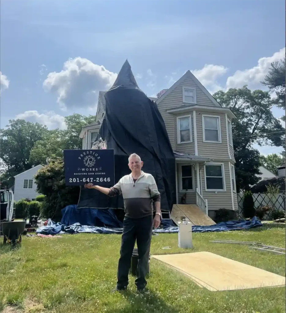 Sunlit New Jersey home showcasing updated gray siding installed by local contractors